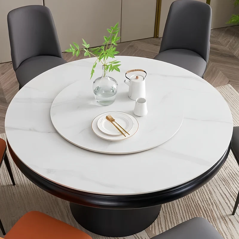 Table de salle à manger ronde avec plateau en pierre frittée et rallonge escamotable pivotante.