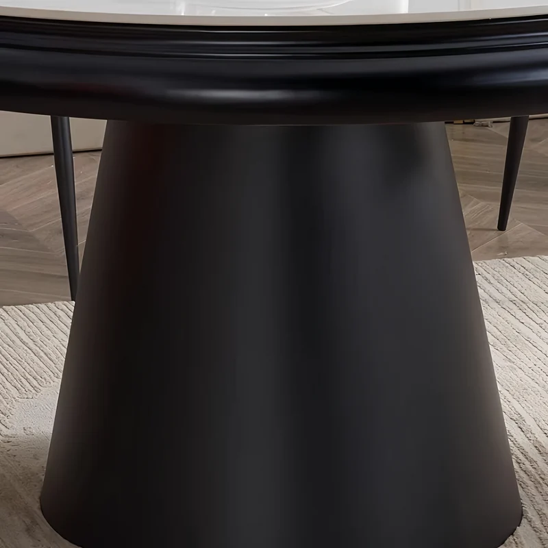 Table de salle à manger ronde avec plateau en pierre frittée et rallonge escamotable pivotante.