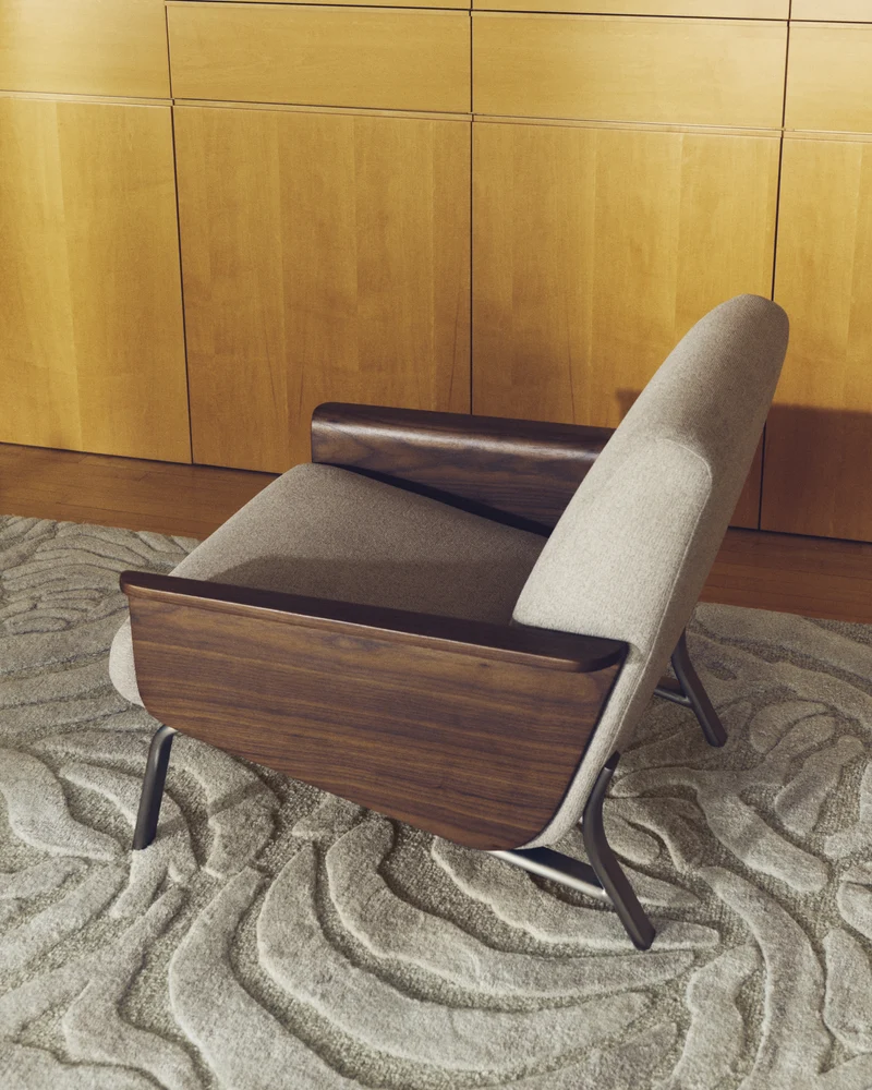 Amsen light brown armchair in walnut plywood with legs in brushed stainless steel