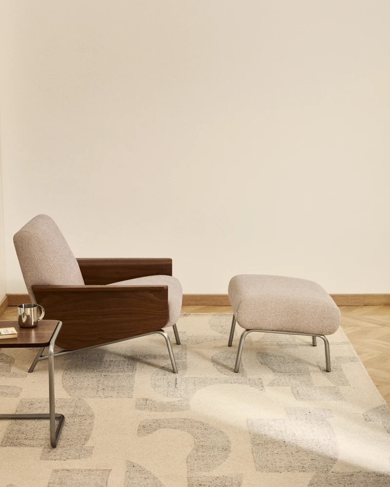 Amsen light brown armchair in walnut plywood with legs in brushed stainless steel
